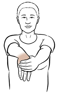 Woman doing wrist flexion exercise.